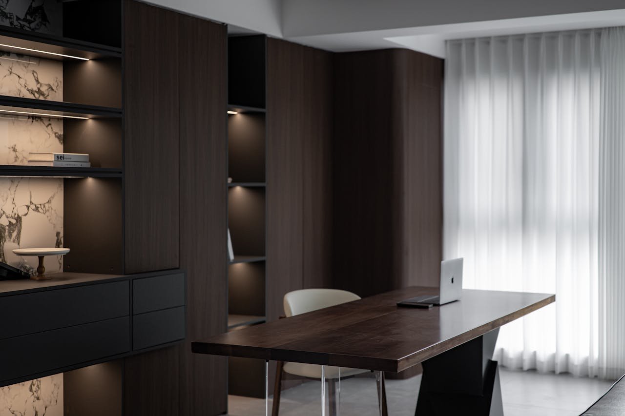 Sleek and stylish home office with wooden furniture and modern decor, exuding a minimalist aesthetic.
